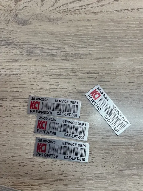 Close-up of KCI service department asset tags freshly printed by STL Asset Solutions
