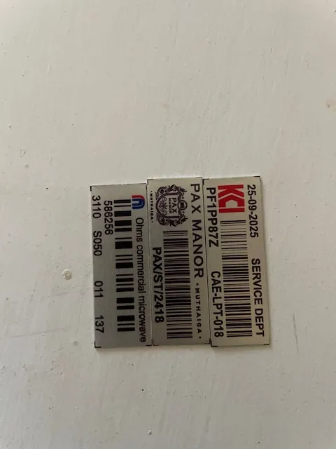 Close-up of a Pax Manor Muthaiga asset tag showing department, asset code and barcode